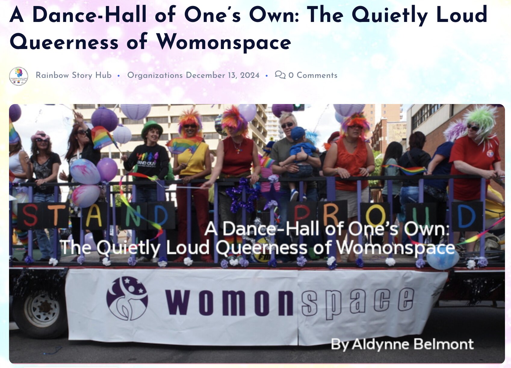 Screenshot of an article titled 'A Dance-Hall of One's Own: The Quietly Loud Queerness of Womonspace' by Aldynne Belmont, published by Rainbow Story Hub on December 13, 2024. The featured image shows a group of people at a Pride parade standing on a float behind a banner reading 'womonspace' with 'STAND PROUD' in rainbow letters. Participants wear colorful outfits, rainbow accessories, and festive wigs in purple, pink, orange, and other bright colors, celebrating LGBTQ+ pride.