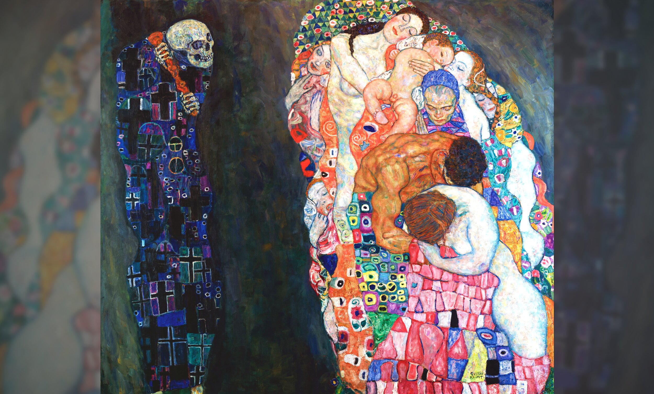 On the left stands a skeletal figure representing Death—a skull-headed form draped in a dark robe covered in crosses, circles, and geometric patterns in deep blues, blacks, and purples, gazing toward the right. On the right, a dense, intertwined mass of human figures representing Life cluster together in sleep or reverie—infants, adults, and elders pressed close, their bodies wrapped in richly decorated robes and garments featuring Klimt's signature mosaic-like patterns of reds, pinks, oranges, and greens. The figures of Life face away from or remain oblivious to Death's presence. The background is a murky, painterly dark green-grey. 