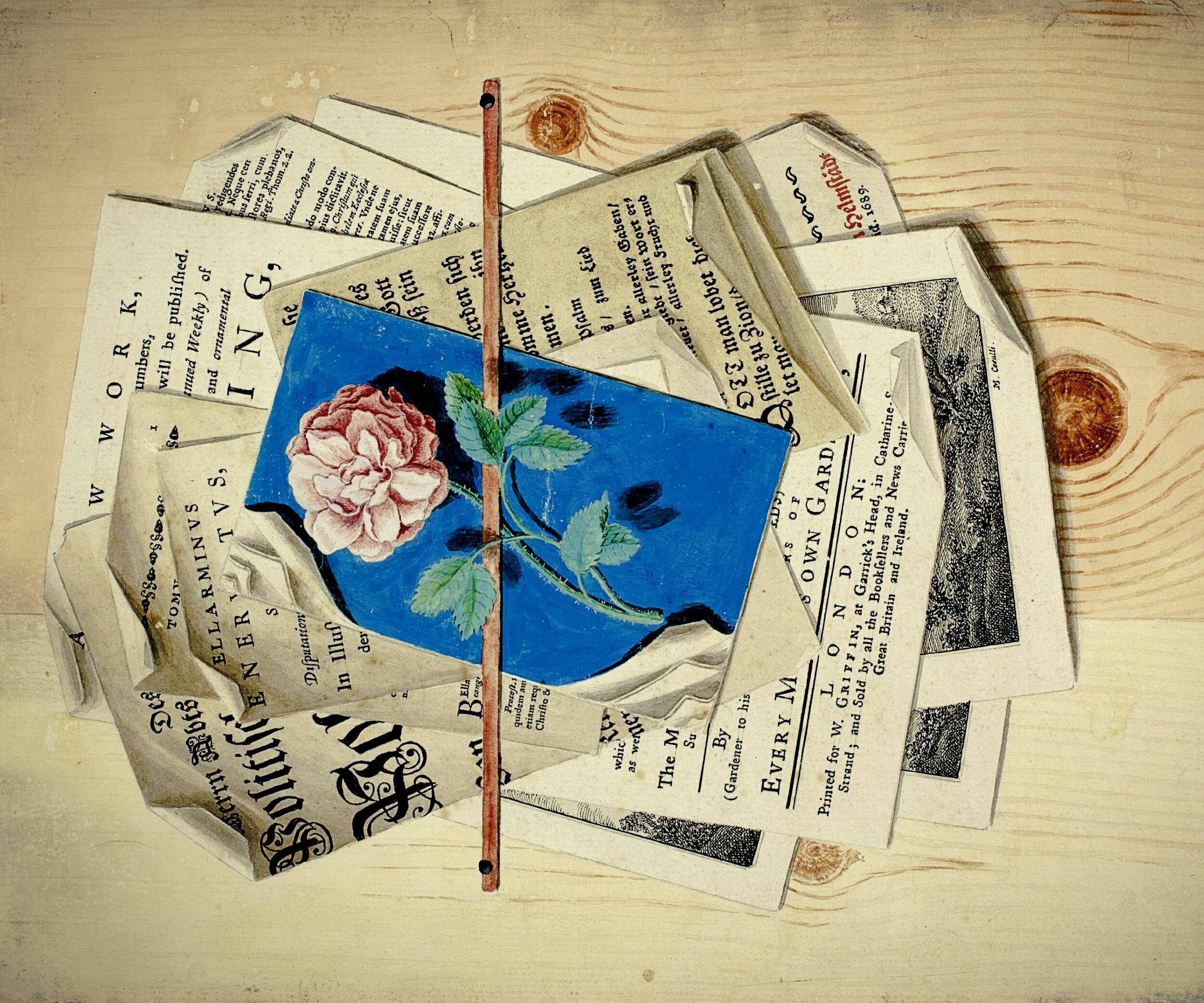A trompe-l'œil painting depicting a scattered arrangement of printed papers, pamphlets, and book pages pinned to a light wood-grain surface by a vertical red stick or stylus. At the centre is a crumpled blue card bearing a detailed botanical illustration of a pink cabbage rose with green leaves on a dark background. The surrounding papers include fragments of English, German, and Latin text — visible phrases include 'LONDON,' 'WORK,' 'EVERY M[ONTH],' 'Printed for W. Griffin,' 'ELLARMINUS GENERTVS,' and a German title in red Gothic script reading 'Helmstädt, 1689.' The papers vary in style from English pamphlet typography to German blackletter, suggesting a multilingual 18th-century scholarly or publishing context. The overall composition mimics the look of real layered documents with careful attention to shadow and paper curl.