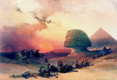 A historical-style painting of a desert landscape at sunset, with the Great Sphinx of Giza and a pyramid in the background. A group of travelers and camels crosses the desert while several people and camels lie or rest in the foreground. The sky is filled with warm pink, orange, and golden clouds, creating a dramatic atmosphere.