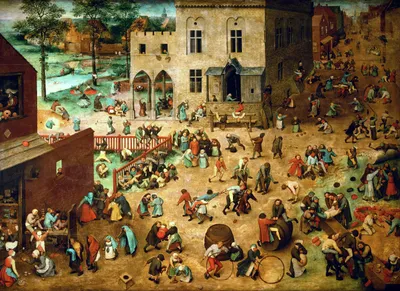 A densely populated Flemish town square overflows with more than two hundred figures—mostly children, some adults—engaged in over eighty distinct games and pastimes. The scene is painted from a high, tilted perspective that flattens the space and allows the eye to travel across clusters of activity: children spinning tops, rolling hoops, playing leapfrog, wrestling, walking on stilts, riding piggyback, blowing up bladders, and marching in procession. In the left foreground, small groups sit at a table and on the ground. A red wooden fence bisects the mid-ground. At centre-left, a large stone building with Gothic arched doorways anchors the composition. The background opens onto a river, green fields, and a receding street. No single focal point—every corner holds another small drama of play.