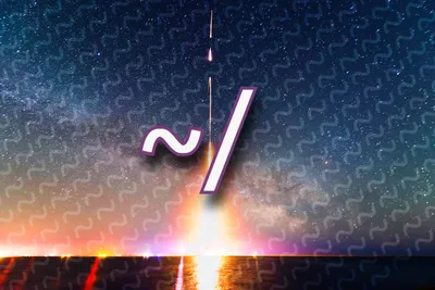 A rocket launches at night from a flat shoreline, its long-exposure trail streaking straight up through a star-filled sky with the Milky Way arching behind it. Orange, pink, and white light glows along the horizon and reflects on the water below. Over the center of the image, a large white '~/' with a purple outline sits on top of a faint repeating pattern of tilde characters that covers the sky.