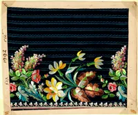 Antique textile sample mounted on a tan card, featuring black silk fabric with horizontal teal wave-stitched lines. Along the lower edge runs a colorful floral embroidery border with pink and yellow lilies, red poppies, pink roses, brown carnation-like blooms, and clusters of small pink and white flowers, connected by green and teal leaves. A row of small white and pink flowers forms a trim along the very bottom edge. Handwritten catalog markings '1992,' 'vie.,' and '537.' appear in the left margin.